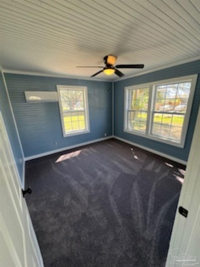 spare room featuring carpet floors, a wealth of natural light, and ceiling fan