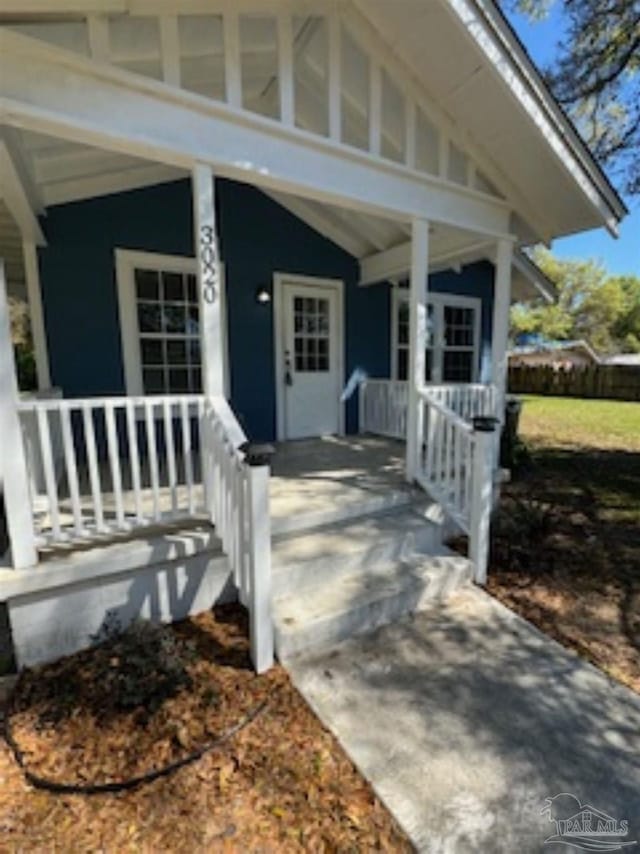 view of exterior entry featuring a porch