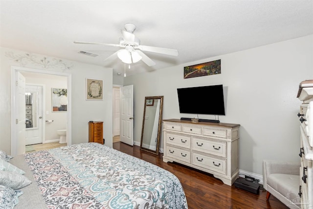 bedroom featuring ceiling fan, dark hardwood / wood-style flooring, and connected bathroom