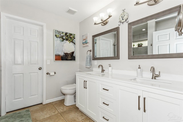 bathroom featuring tile patterned floors, vanity, and toilet