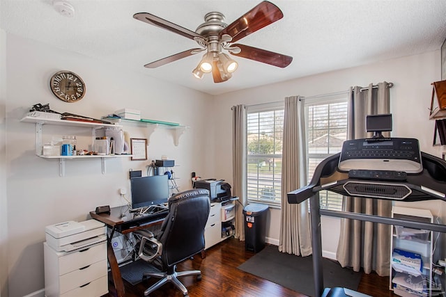 home office featuring dark hardwood / wood-style floors, ceiling fan, and a textured ceiling