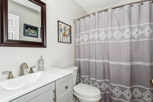 bathroom with vanity, curtained shower, and toilet