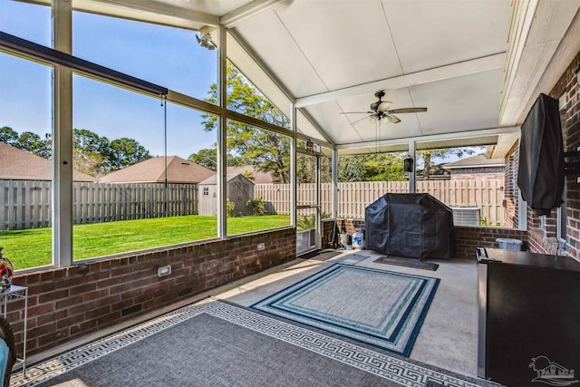 sunroom / solarium featuring lofted ceiling with beams, a wealth of natural light, and ceiling fan