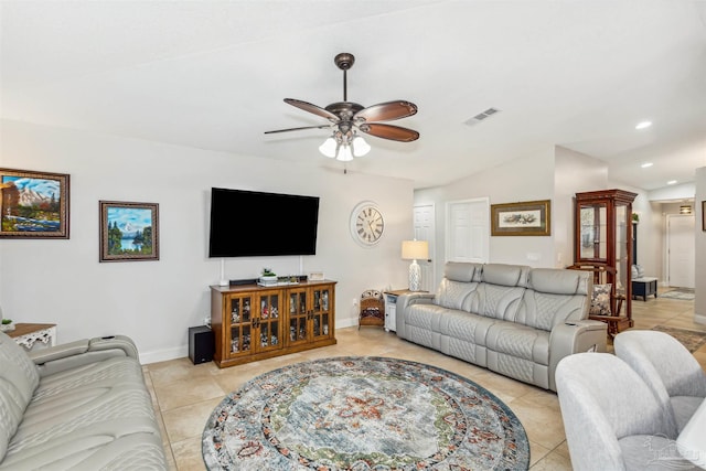 tiled living room with ceiling fan and vaulted ceiling