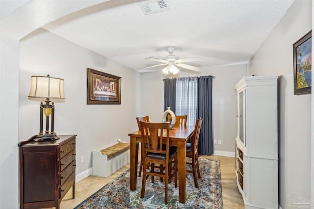 dining area with ceiling fan and a textured ceiling