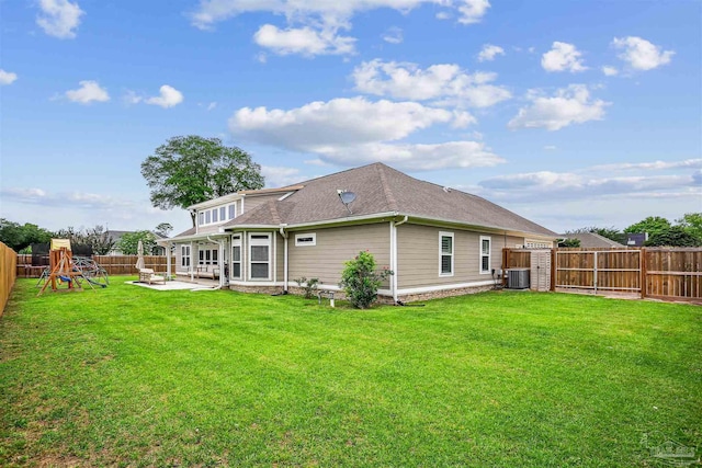 4121 Castle Gate Dr, Pace, FL 32571 - back of house featuring a patio area, a playground, cooling unit, and a shingled roof