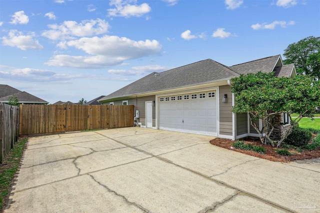 4121 Castle Gate Dr, Pace, FL 32571 - view of side of home featuring concrete driveway, a garage, and roof with shingles