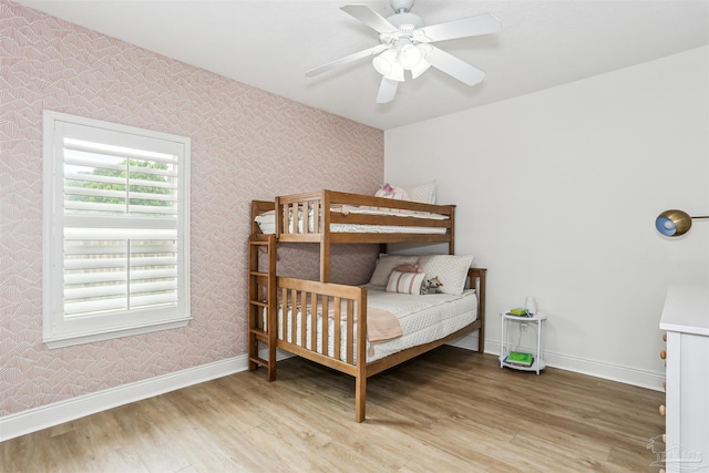 4121 Castle Gate Dr, Pace, FL 32571 - bedroom with wallpapered walls, wood finished floors, baseboards, and ceiling fan