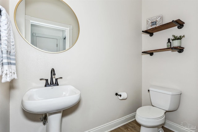 4121 Castle Gate Dr, Pace, FL 32571 - half bath featuring toilet, baseboards, wood finished floors, and a sink