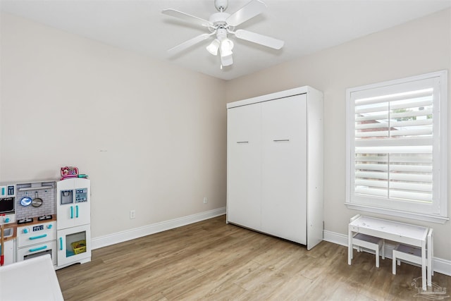 4121 Castle Gate Dr, Pace, FL 32571 - game room with light wood-style flooring, ceiling fan, and baseboards