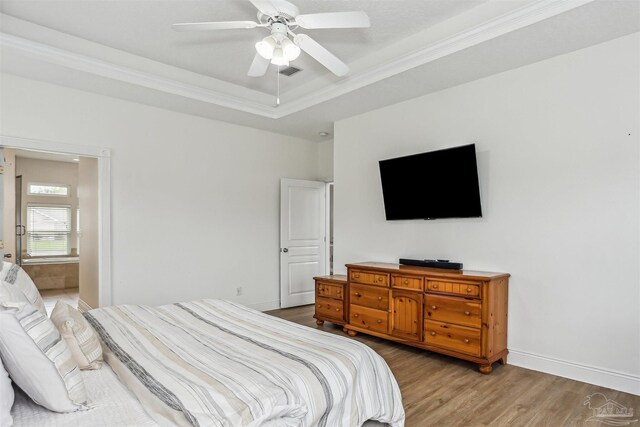 4121 Castle Gate Dr, Pace, FL 32571 - bedroom with wood finished floors, a tray ceiling, ornamental molding, baseboards, and a ceiling fan