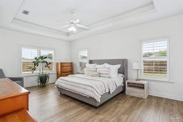 4121 Castle Gate Dr, Pace, FL 32571 - bedroom with a tray ceiling, wood finished floors, baseboards, and ceiling fan
