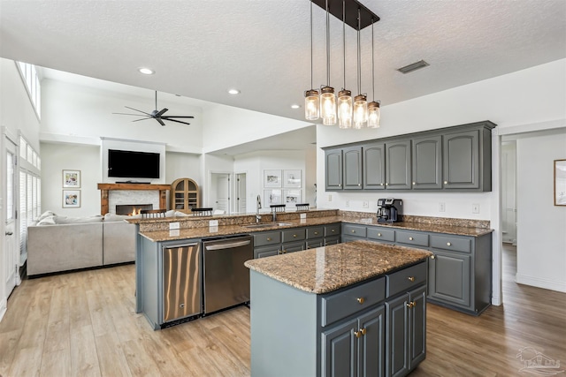 4121 Castle Gate Dr, Pace, FL 32571 - kitchen featuring dishwasher, a sink, a textured ceiling, a ceiling fan, and a peninsula