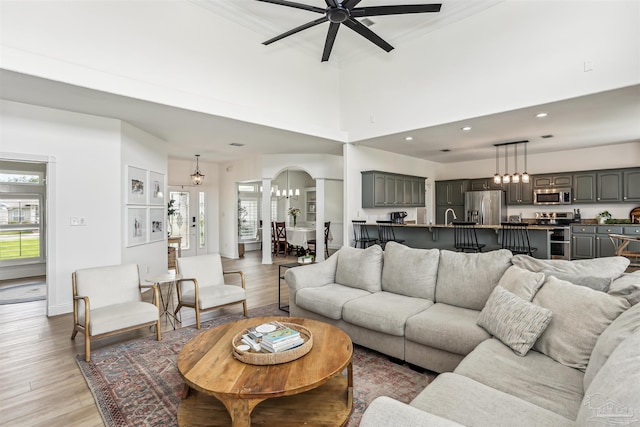 4121 Castle Gate Dr, Pace, FL 32571 - living room with light wood-type flooring, ceiling fan, arched walkways, a chandelier, and recessed lighting
