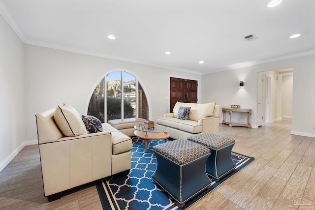 living room featuring hardwood / wood-style flooring and crown molding