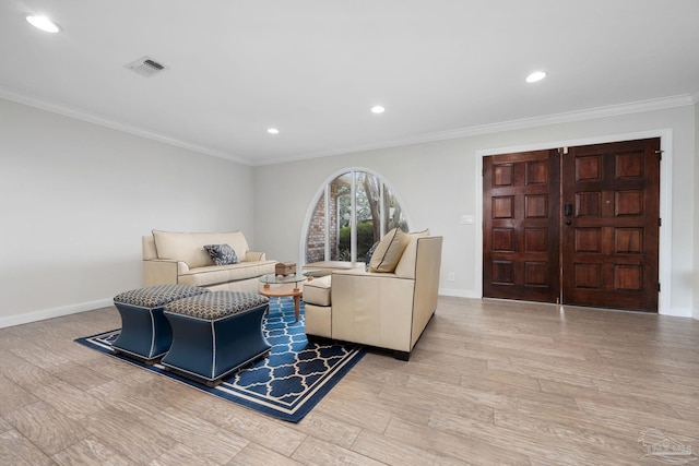 living room featuring light hardwood / wood-style floors and ornamental molding