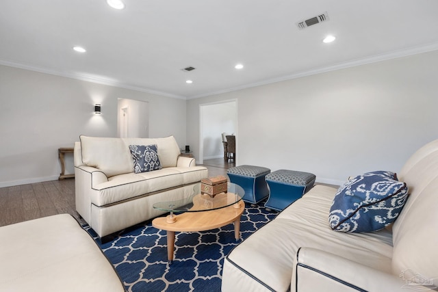 living room featuring hardwood / wood-style flooring and ornamental molding