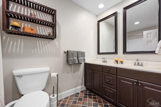 bathroom with toilet and vanity