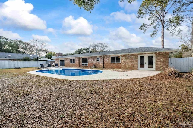 view of pool featuring french doors and a patio