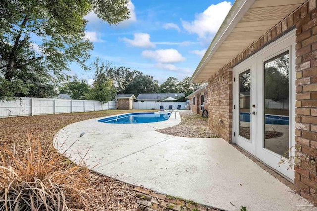 view of pool with a patio area and french doors