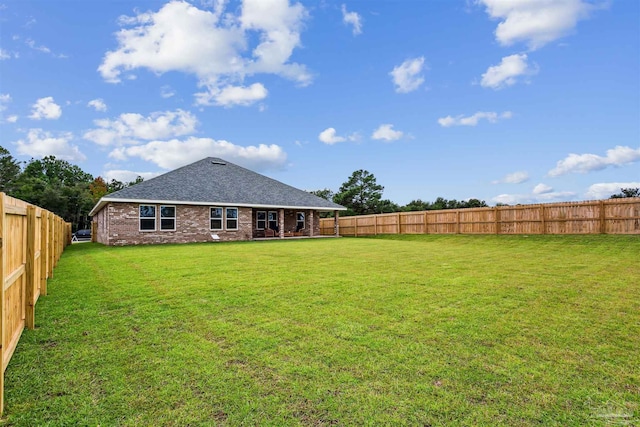 back of house with a yard