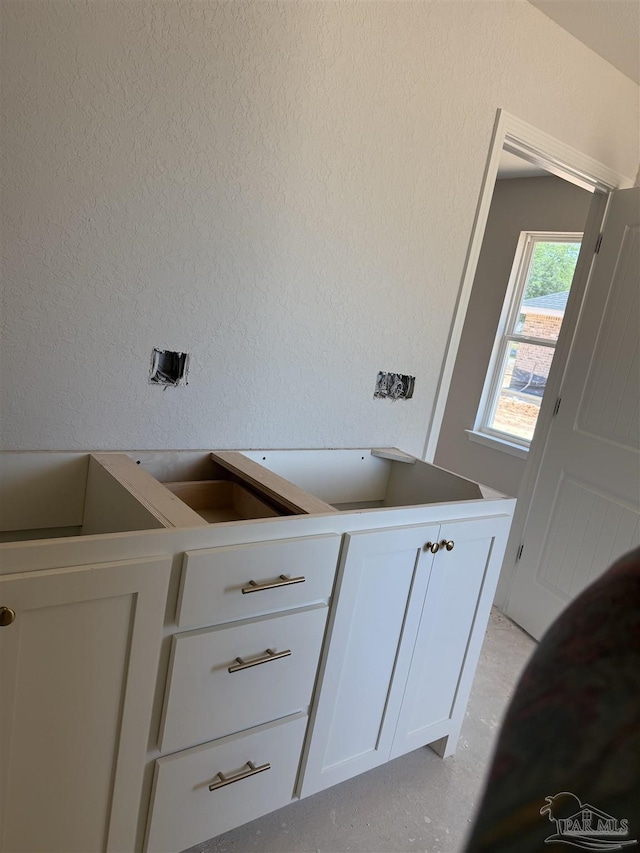 washroom featuring a textured wall