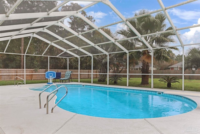 view of swimming pool with glass enclosure and a patio area