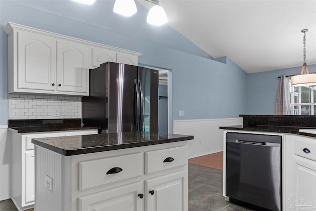 kitchen with pendant lighting, backsplash, stainless steel appliances, and white cabinetry