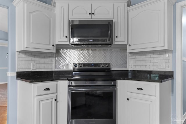 kitchen with white cabinetry, decorative backsplash, stainless steel electric range oven, and dark stone countertops