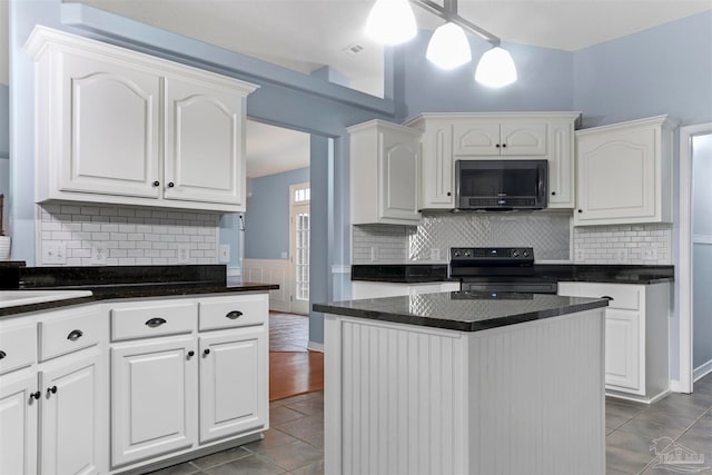 kitchen with white cabinetry and black appliances