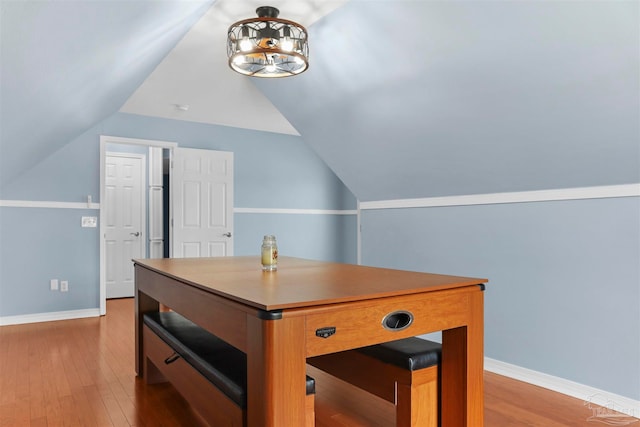 office area featuring light hardwood / wood-style floors and vaulted ceiling