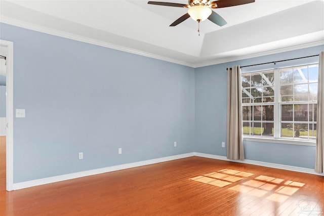 spare room featuring hardwood / wood-style floors, ceiling fan, and crown molding