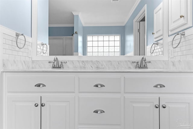 bathroom featuring tasteful backsplash, crown molding, a shower with door, and vanity