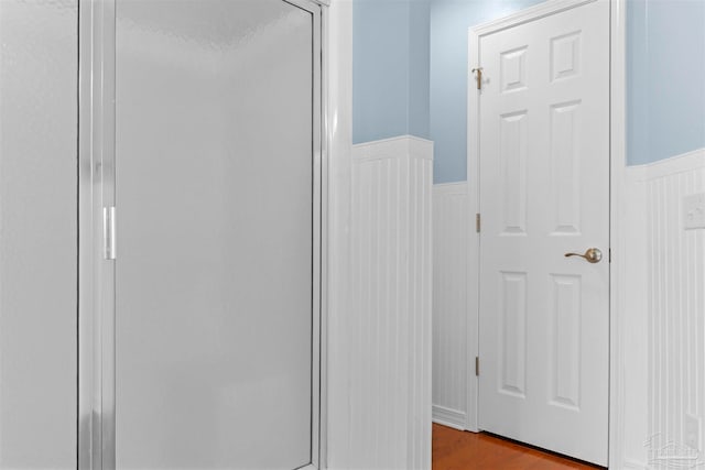 bathroom featuring hardwood / wood-style flooring and an enclosed shower