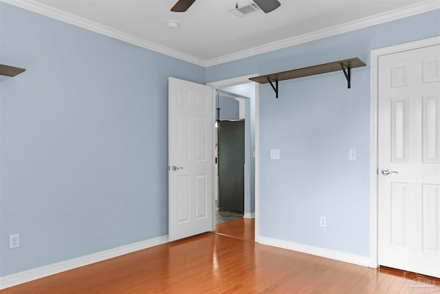 unfurnished bedroom with wood-type flooring, ceiling fan, and crown molding