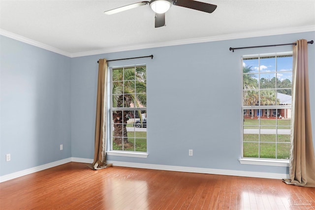 spare room featuring hardwood / wood-style flooring, ceiling fan, and crown molding