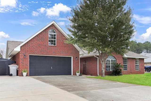 view of front of house with a garage and a front lawn