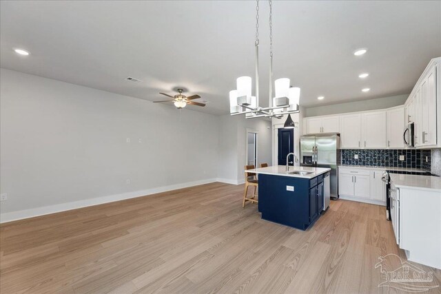 interior space with light hardwood / wood-style flooring and ceiling fan with notable chandelier