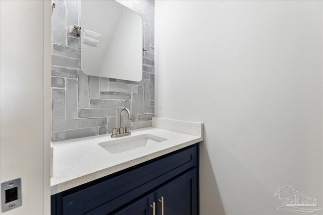 bathroom with tasteful backsplash and vanity