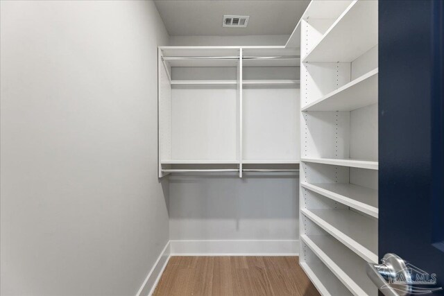 walk in closet featuring hardwood / wood-style flooring