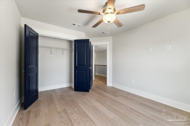 unfurnished bedroom featuring a closet, ceiling fan, and light wood-type flooring