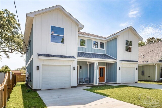 view of front of home with a garage and a front lawn