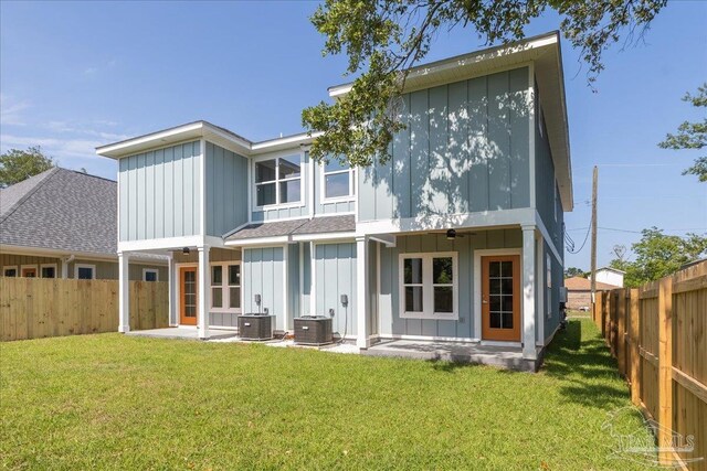 back of property with a patio area, a lawn, and central AC unit