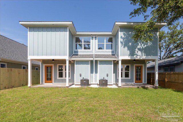 rear view of house with a yard, central air condition unit, and ceiling fan