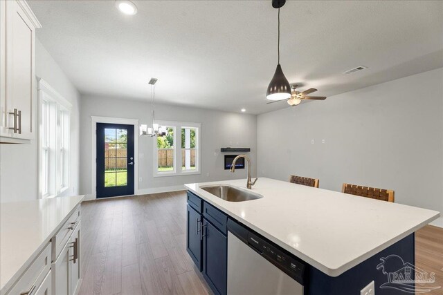 kitchen featuring sink, appliances with stainless steel finishes, a wealth of natural light, and white cabinetry