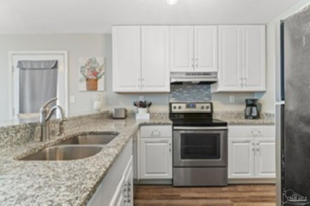 kitchen featuring a sink, white cabinets, under cabinet range hood, and stainless steel appliances