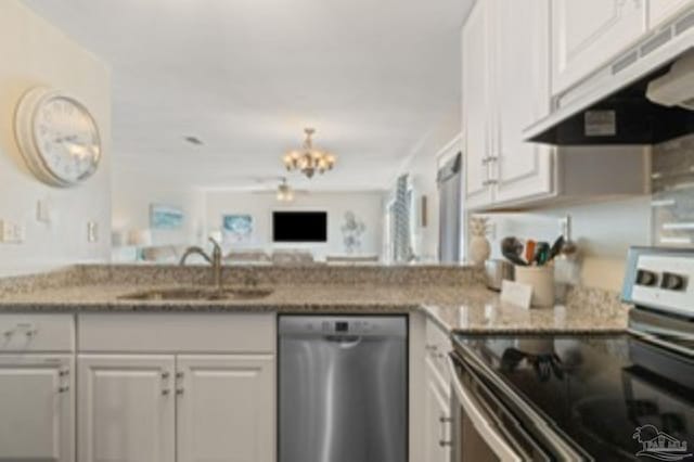 kitchen featuring appliances with stainless steel finishes, a sink, white cabinets, and under cabinet range hood