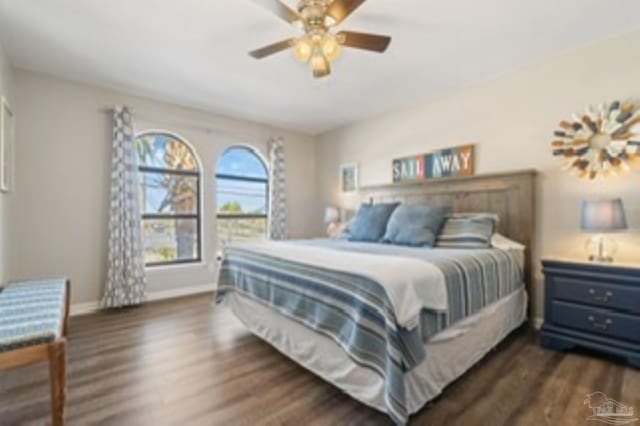 bedroom with dark wood-style floors, baseboards, and a ceiling fan