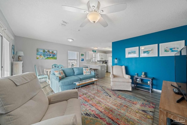7464 Sunset Harbor Dr Unit 133, Navarre Beach, FL 32566 - living room with hardwood / wood-style flooring, ceiling fan, and a textured ceiling