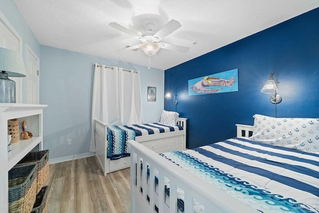 7464 Sunset Harbor Dr Unit 133, Navarre Beach, FL 32566 - bedroom featuring ceiling fan, light hardwood / wood-style flooring, and a textured ceiling